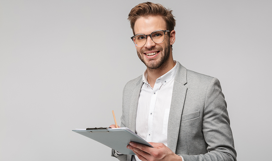 portrait-of-happy-young-man-in-eyeglasses-holding--4U655XX